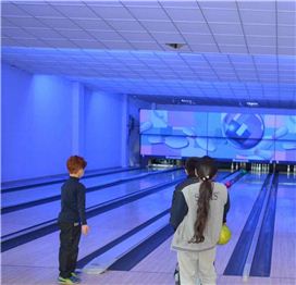 Students learning to play Bowling and refining their coordination skills